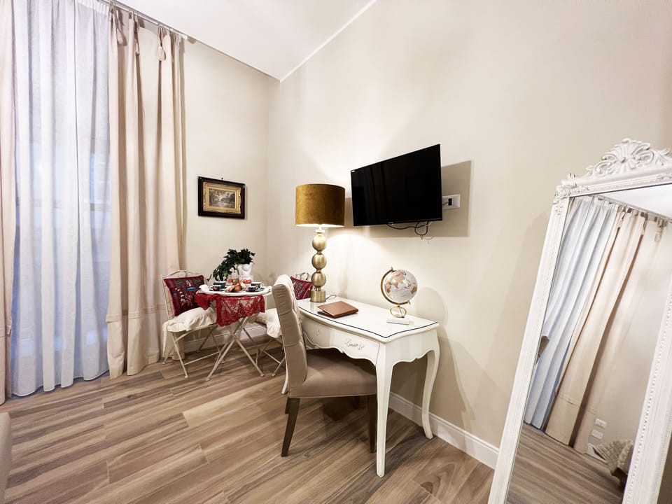 Deluxe Room | Living area | 54-inch plasma TV with cable channels