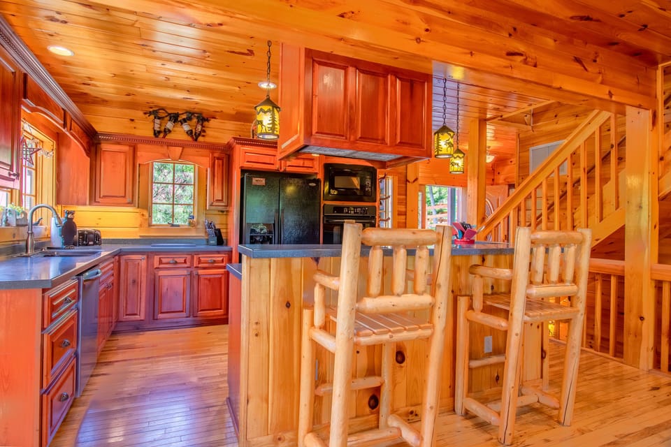 Large kitchen with plenty of counter space, double oven, and seating at bar area