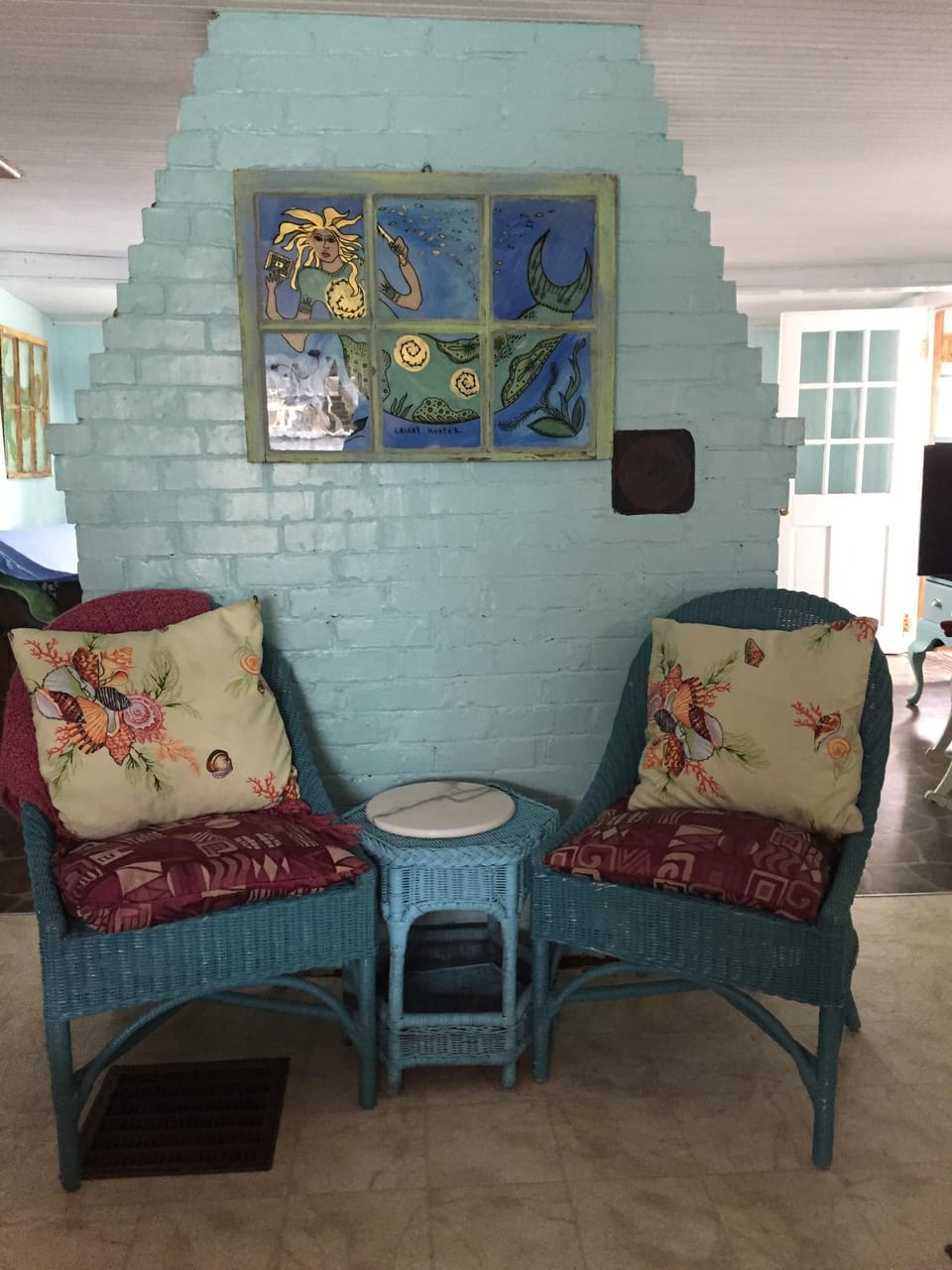 Seating on the kitchen side of the fireplace.