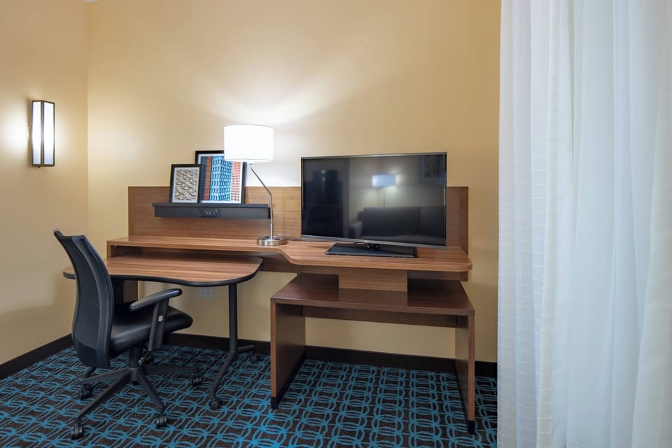 Desk, laptop workspace, blackout drapes, iron/ironing board