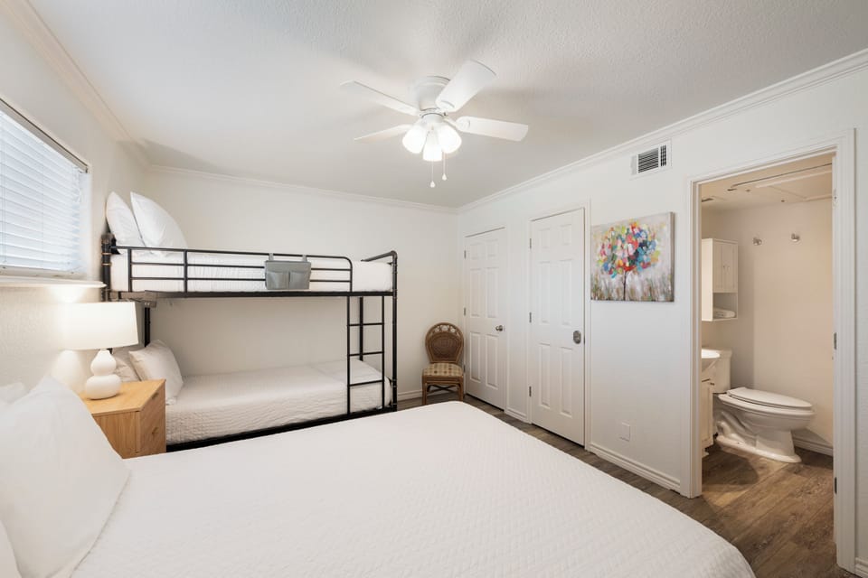 Your spacious room features a comfy queen bed and bunk bed, perfect for families. Cool off with the ceiling fan while kids enjoy their own space.