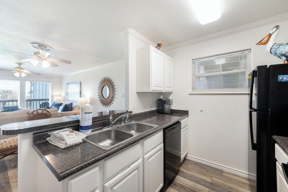 Your fully equipped kitchen features granite countertops, stainless steel sink, and modern appliances - perfect for preparing meals during your stay.