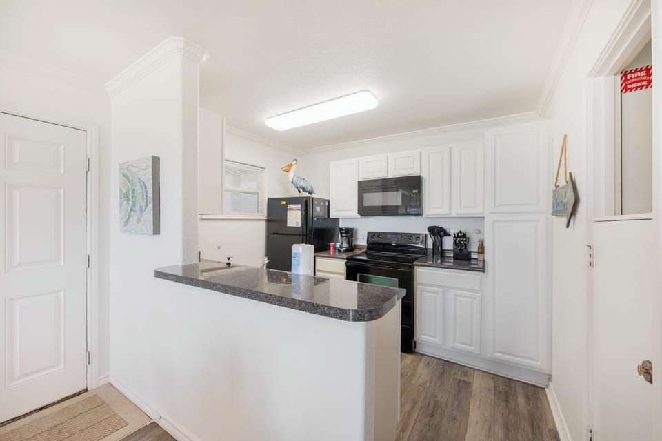Your bright, fully-equipped kitchen features granite countertops and modern appliances, perfect for preparing meals during your stay.