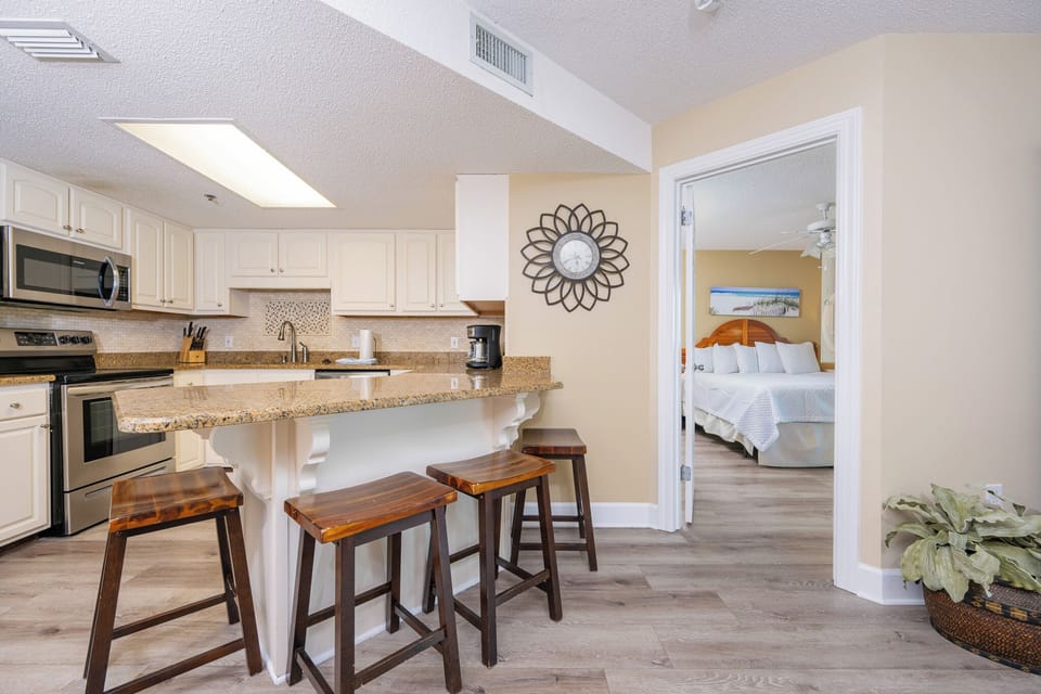 Gather in the kitchen to share laughs across the breakfast bar, feeling the inviting coastal vibe of your getaway