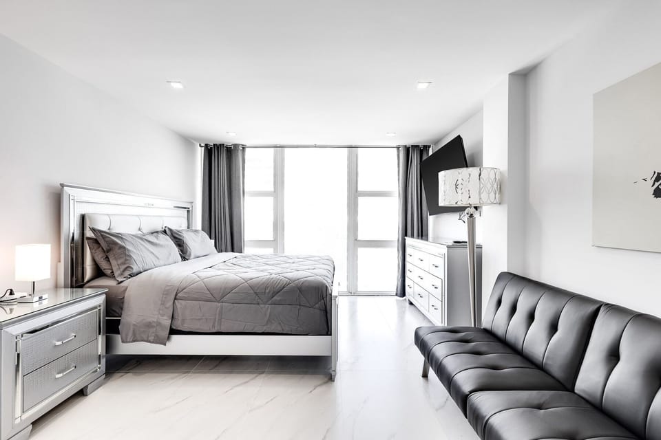 Master bedroom with side  views from your pillow of ocean and beach