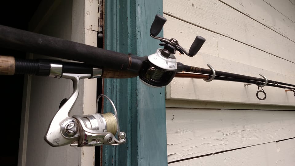 Fishing rods stored in the backyard shed.