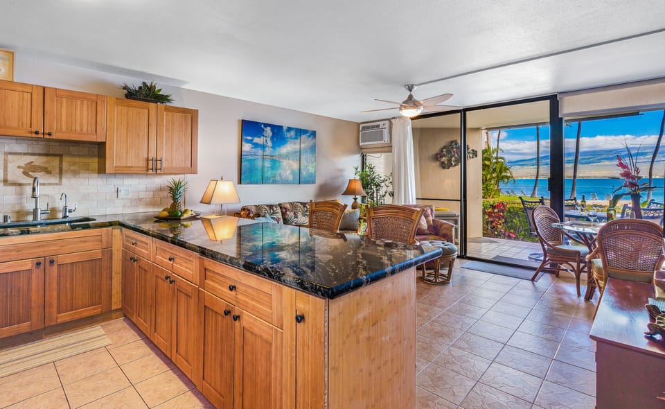 Newly remodeled kitchen with open counter looking out ocean view and living room
