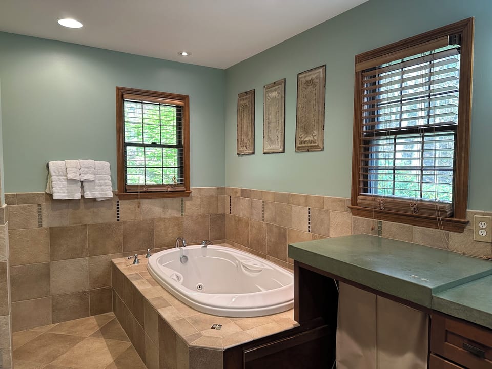 Primary Bath: jacuzzi tub, double sinks, tiled shower with double shower heads