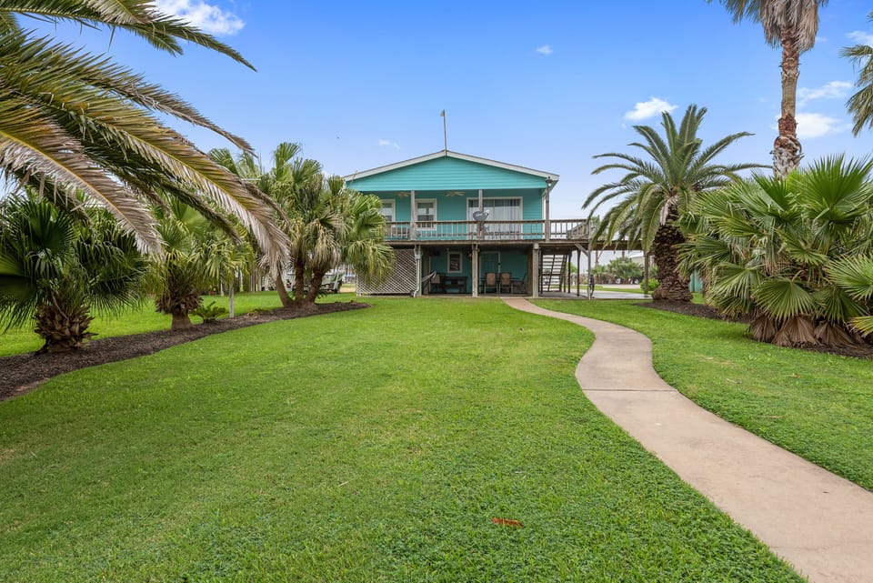 Nicely manicured backyard with mature palms creates a relaxing, coastal feel!