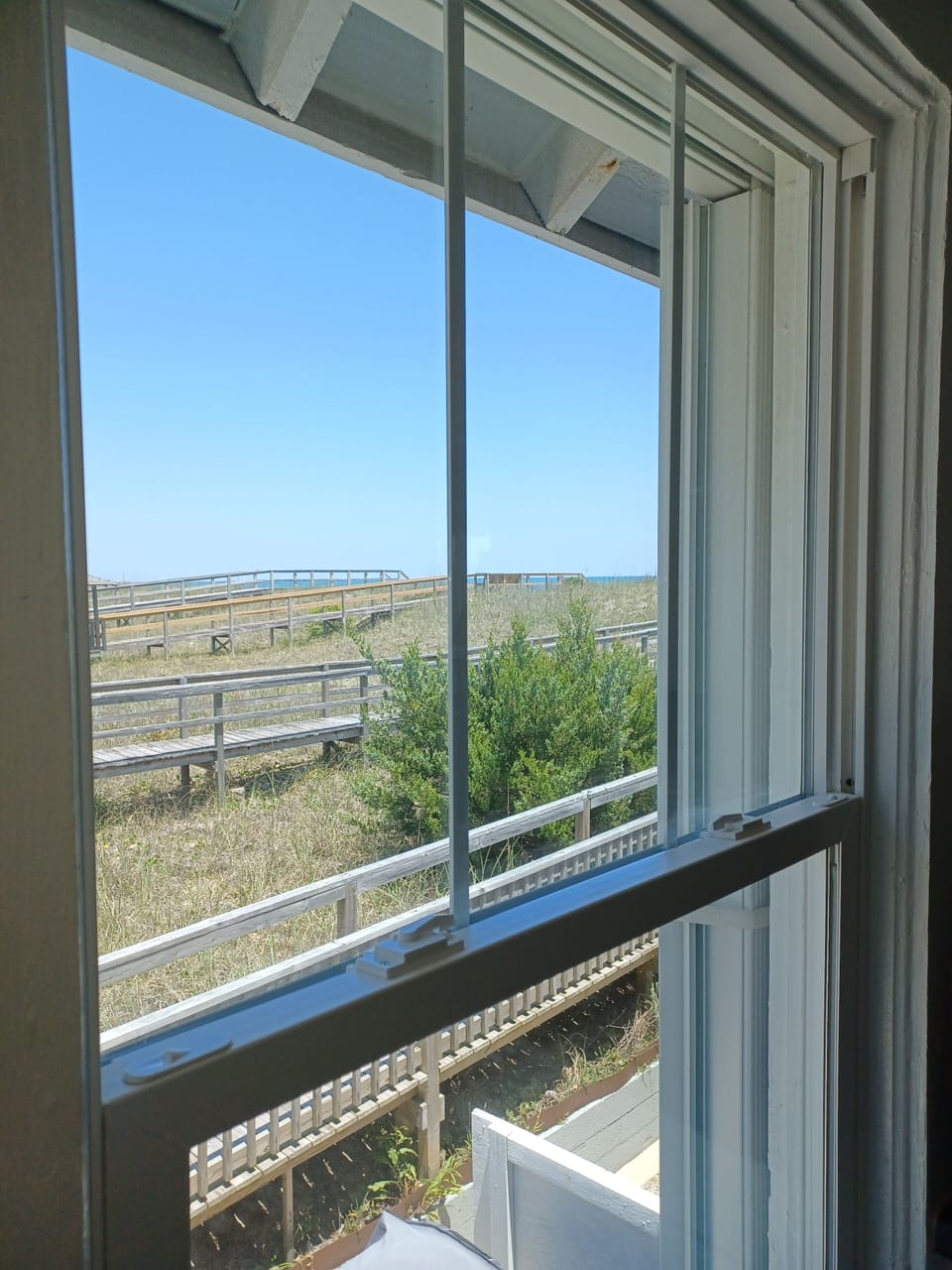 Close up kitchen view of dunes and ocean.