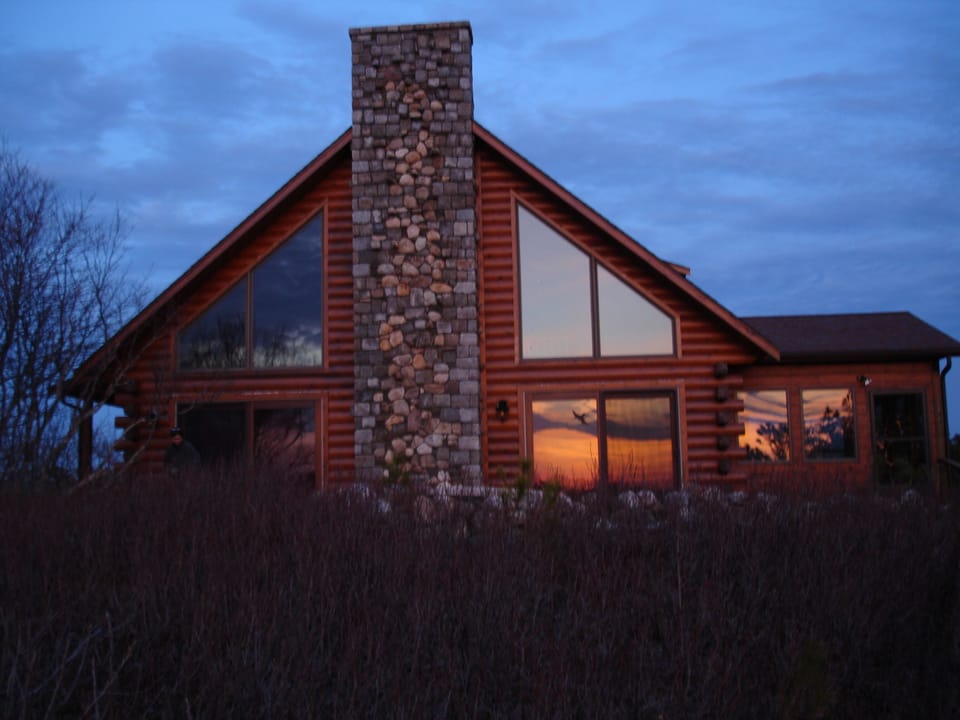 Sunset reflected in the expansive windows facing Shank Painter pond.