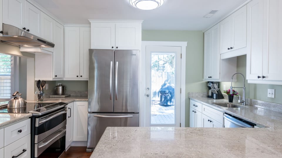 Kitchen leads to back patio, pool and grilling area