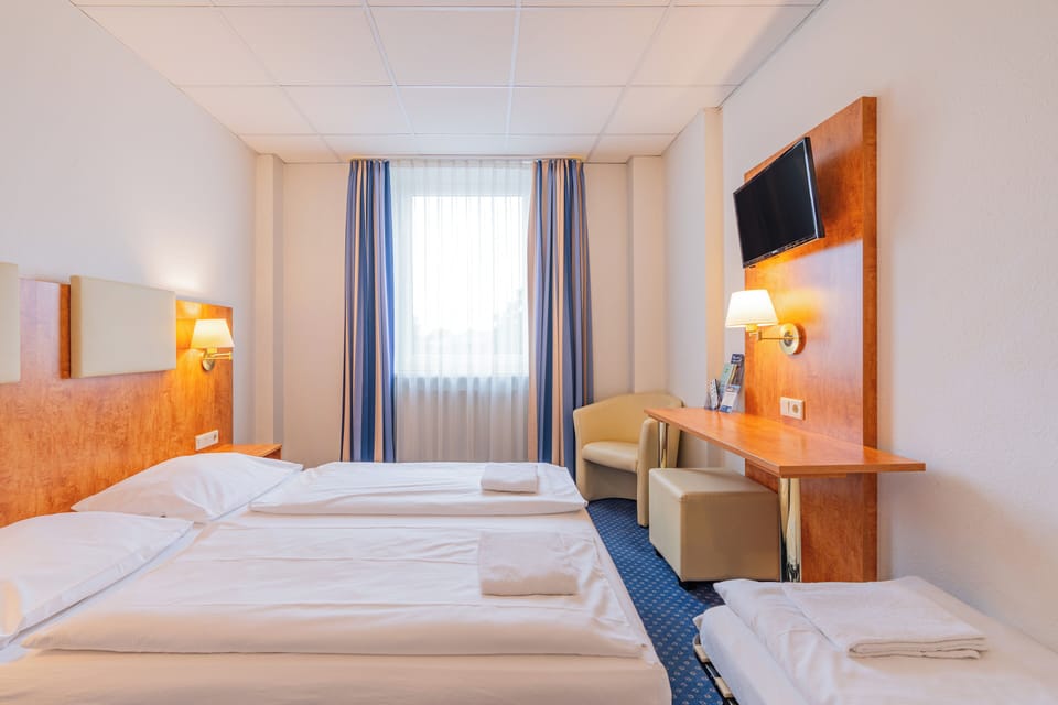 Classic Triple Room | Desk, blackout drapes, iron/ironing board, free WiFi