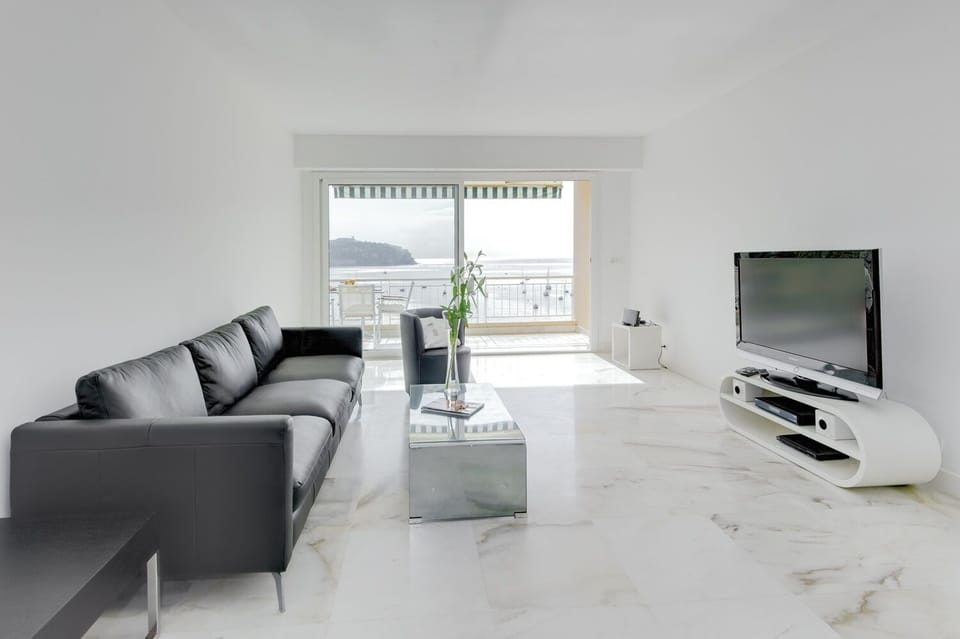 Contemporary living room with access to spacious dining balcony 
