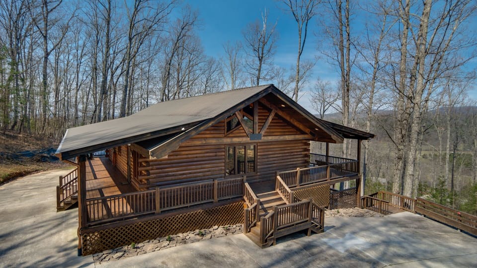 North end of cabin with large concrete parking area at end and side of cabin