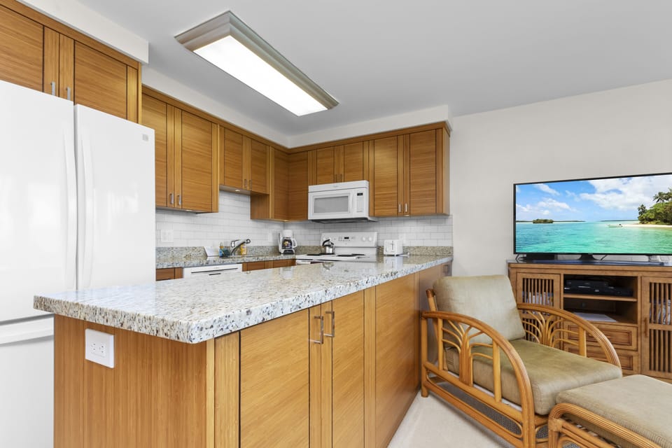 Cook your favorite meals and unwind in this tropical-inspired space with granite counters, modern appliances, and a cozy lounge to relax in after a day of island adventures.