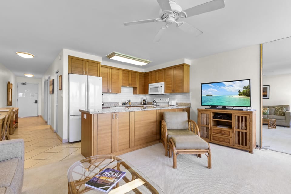 Unwind in your open-concept living space with a fully equipped kitchen, cozy seating, and modern conveniences. The ceiling fan keeps you comfortable while you relax and enjoy your stay.