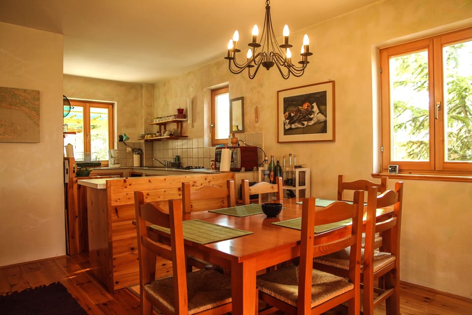 Dining table and the kitchen in the back