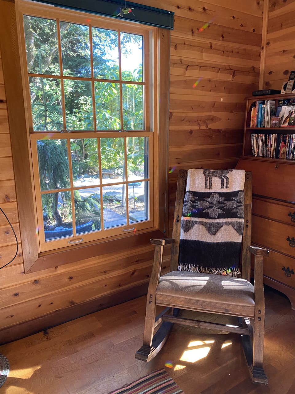 Enjoy one of the many books while relaxing in this comfy rocker.