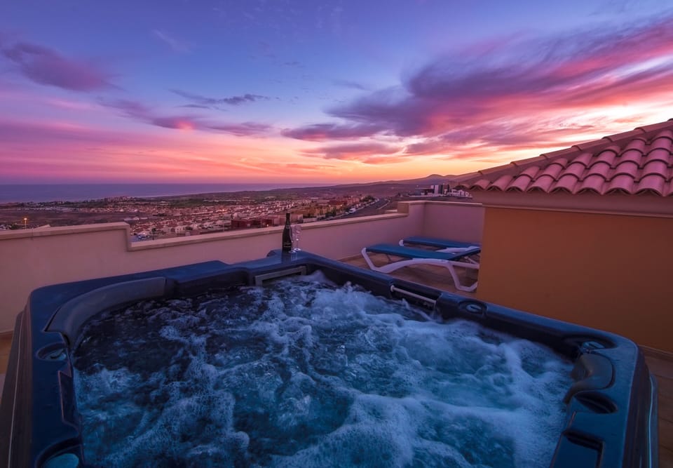 Hot tub on the roof terrace with sun going down, unbeatable views. 