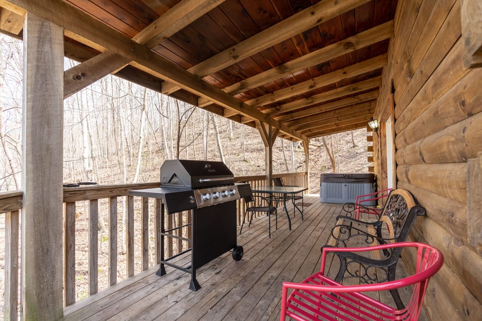 west side of cabin showing propane grill and hot tub 