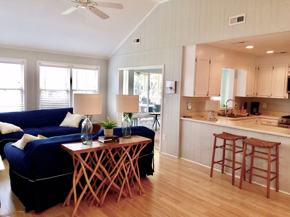 Open concept kitchen - living (tv) room with tall ceilings and ocean views. 