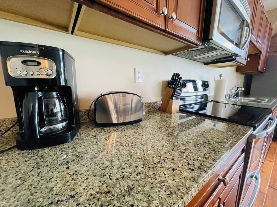 Start your day with a fresh cup of coffee. A high-end coffee maker, toaster, and knife set make meal prep effortless.