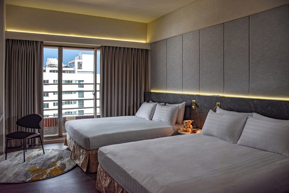 Deluxe Quadruple Room | Down comforters, desk, laptop workspace, blackout drapes