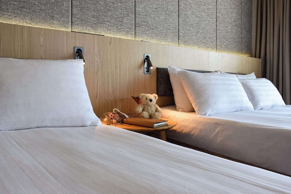 Deluxe Quadruple Room | Down comforters, desk, laptop workspace, blackout drapes