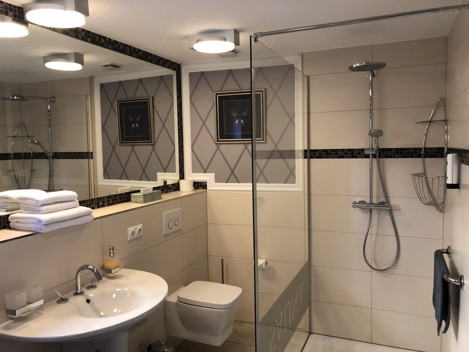 Shower, designer toiletries, hair dryer, towels