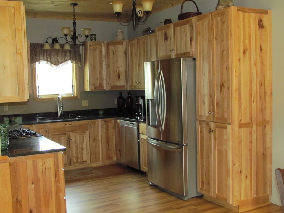 Fully equipped kitchen featuring rustic maple cabinets and granite counter tops.
