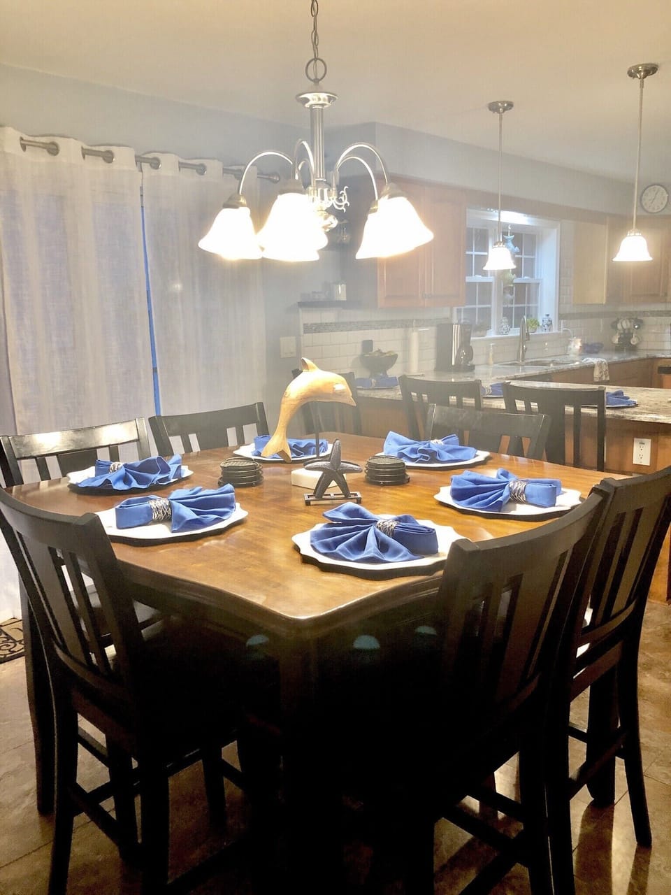 Spacious kitchen seats 12 with deck access that has seating for 16 and gas grill