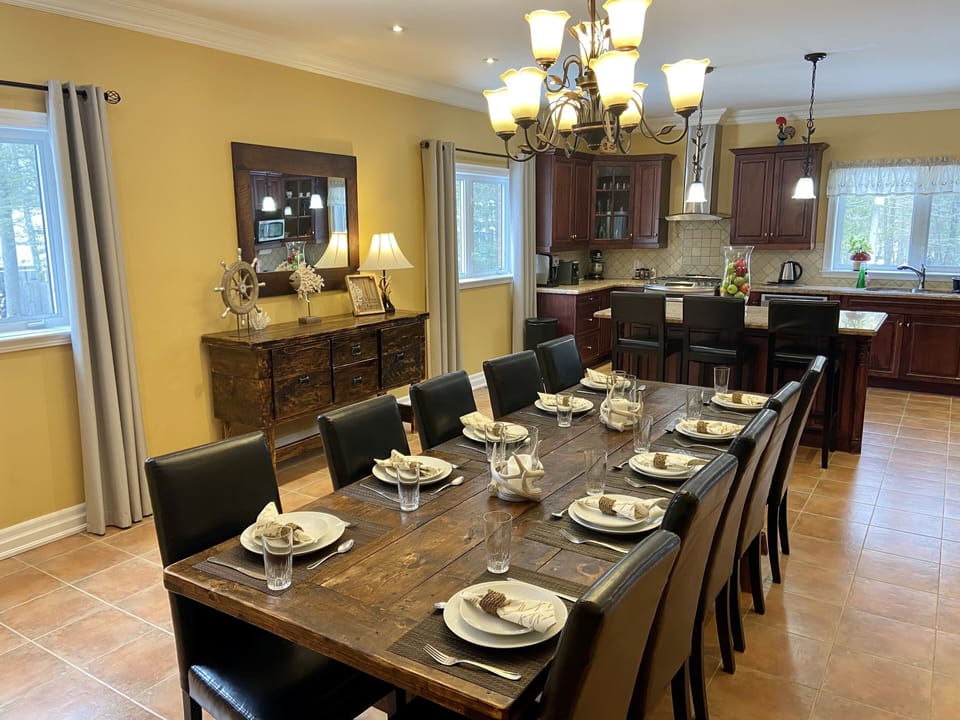 Dining room with huge pine rustic table and can seat large family or group.