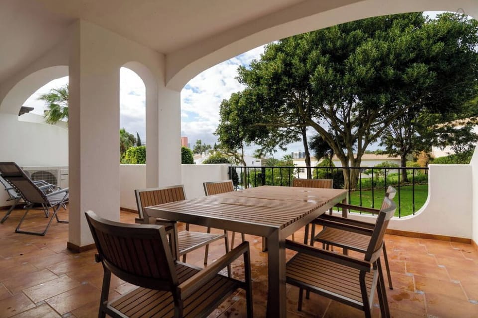 Rear terrace with access via gate to private garden area adjacent to indoor pool