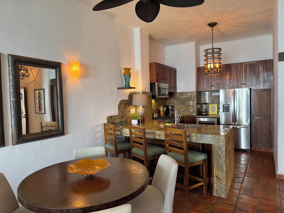 Nicely remodeled kitchen with barstools, stainless appliances & wine fridgem