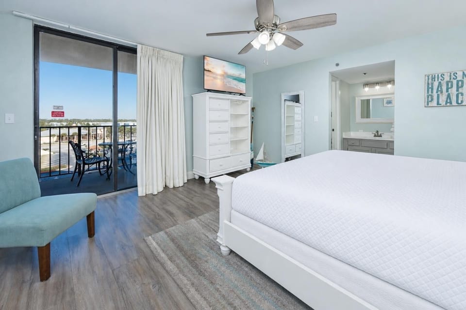 Enjoy restful nights in this serene master with a cozy king bed, inviting decor, and a view from your balcony