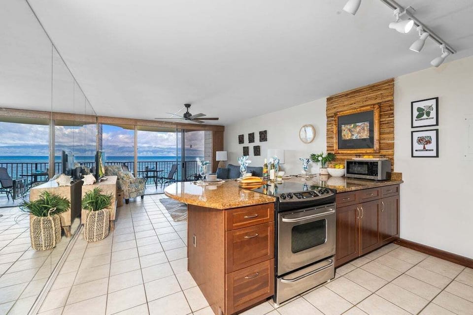Open kitchen layout featuring modern appliances and a large prep area overlooking the sea