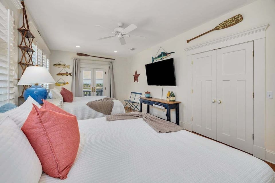 Twin bedroom with large windows and TV