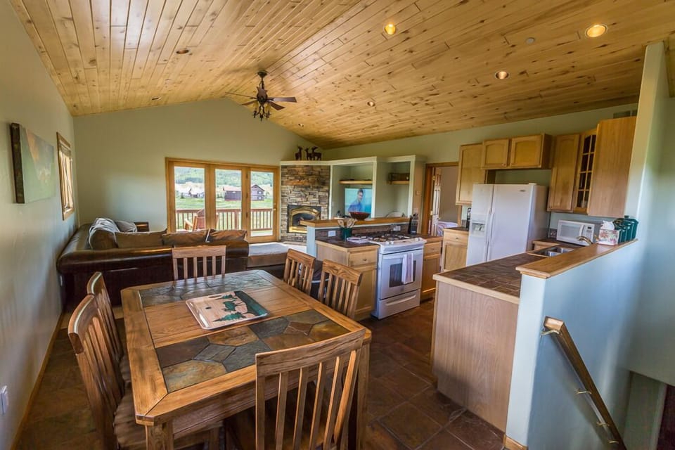 combined kitchen, dining and living room with vaulted Aspen ceilings
