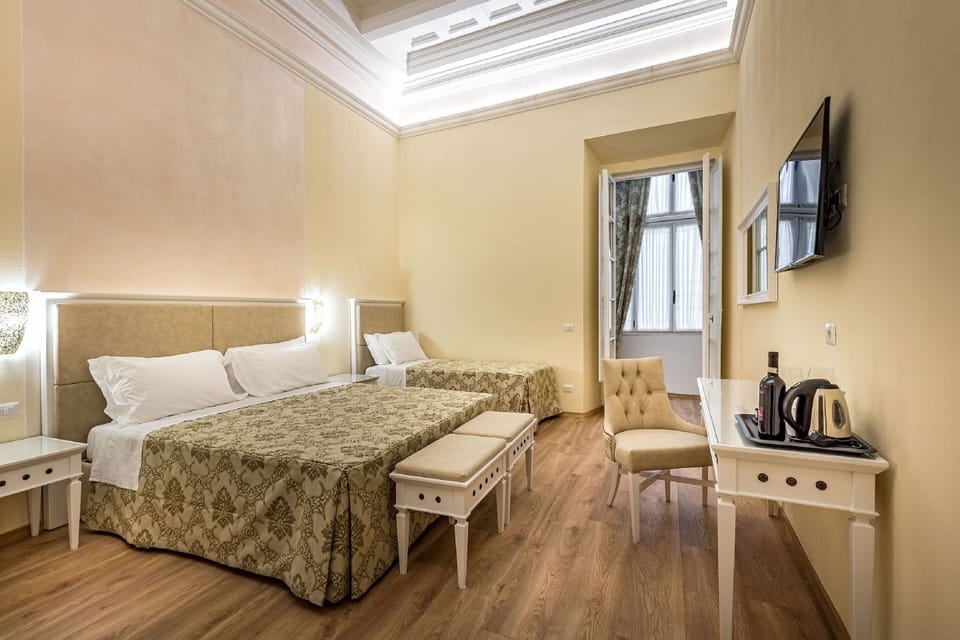 Family Room (Camera Deluxe Familiare) | Minibar, in-room safe, desk, laptop workspace