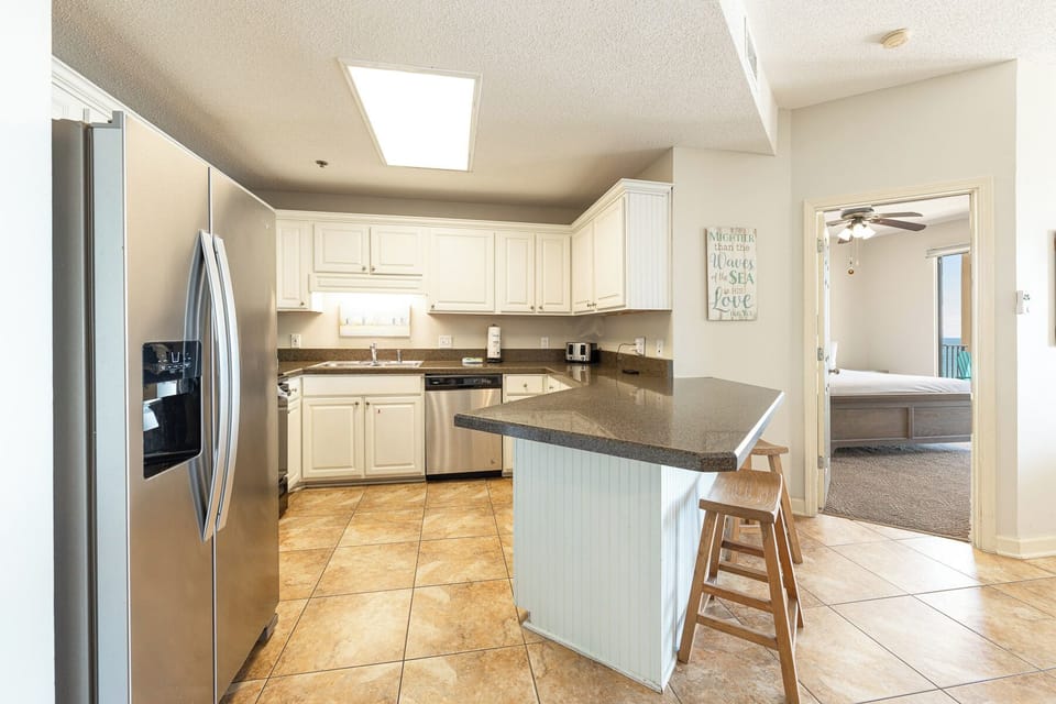 Sunlight brightens the kitchen as you prepare a snack before retreating to the queen guest suite nearby