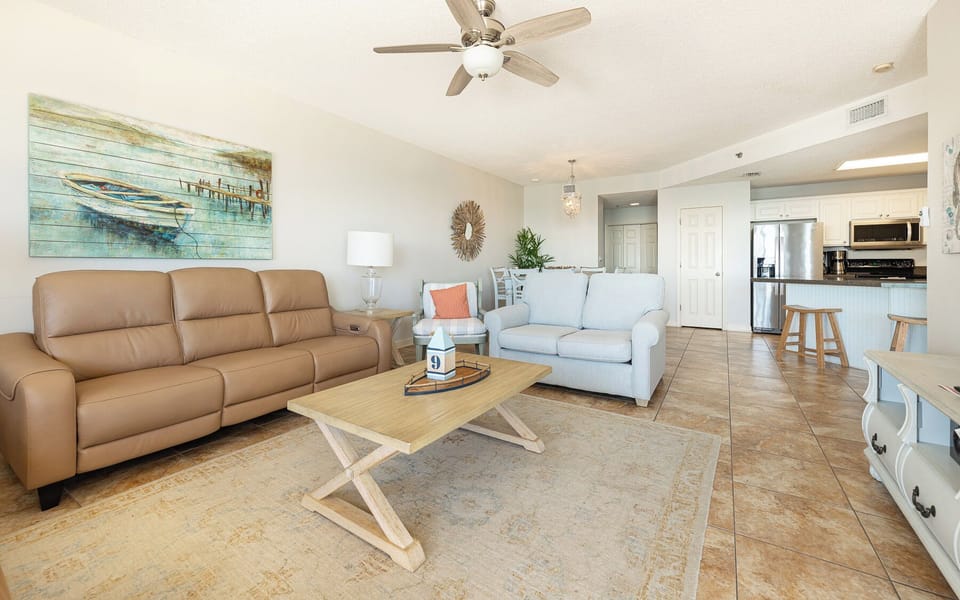 In the living room, your family gathers comfortably on soft seating to chat or watch a favorite movie