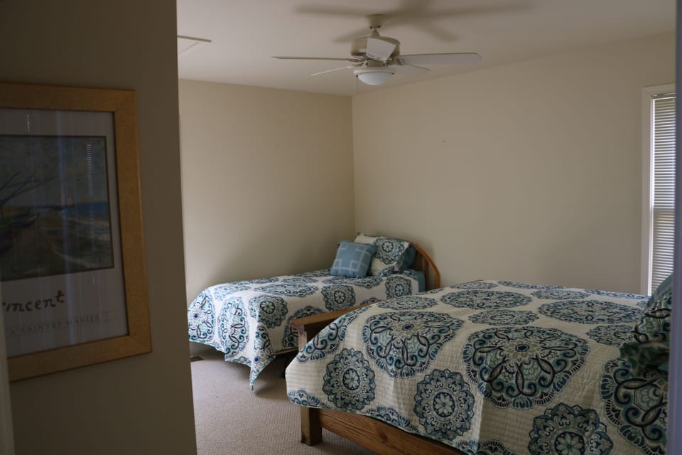 Bedroom on main floor with queen bed and twin bed