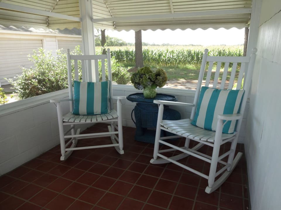 The screened porch looks out on acres of farm land and abundant wildlife.