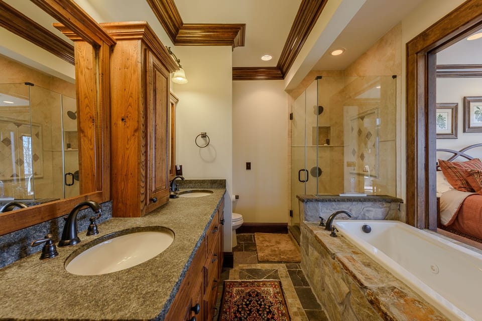 Large Private Master Bathroom with Walk-In Shower, Large Soaking Tub, and Dual Vanities.