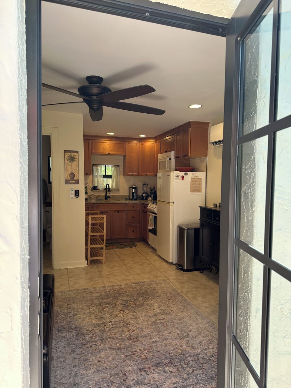 Here, you enter the Cottage through a newly installed bronze impact door. 