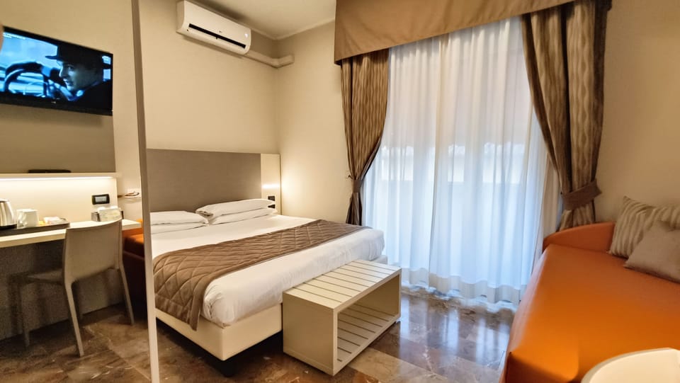 Deluxe Double or Twin Room | Minibar, desk, laptop workspace, blackout drapes