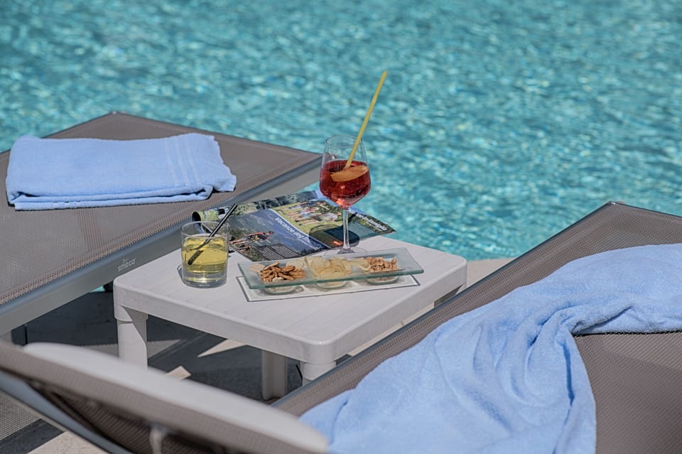 Seasonal outdoor pool, a waterfall pool, pool umbrellas, sun loungers