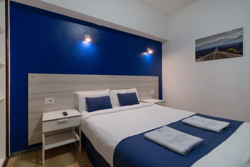 Double or Twin Room, Private Bathroom | Desk, laptop workspace, blackout drapes, iron/ironing board
