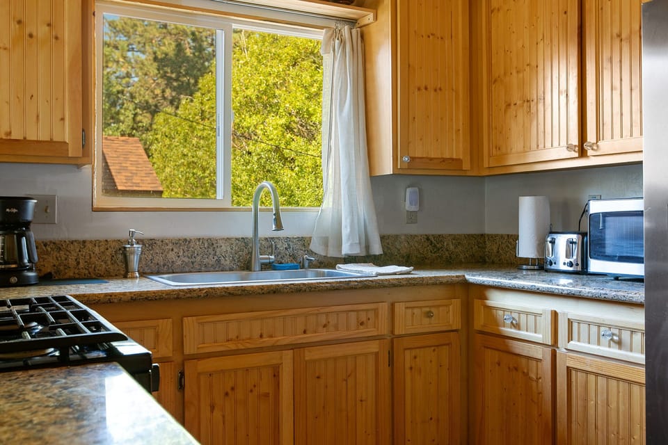 Kitchen includes dishware, cups, utensils, pots and pans